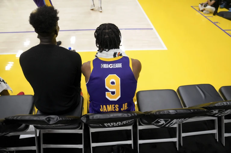 South Bay Lakers guard Bronny James sits on the bench during halftime