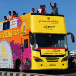 Colorful Coimbatore Vizha 2024 double-decker bus with people celebrating the city festival on Avinashi Road, Coimbatore.