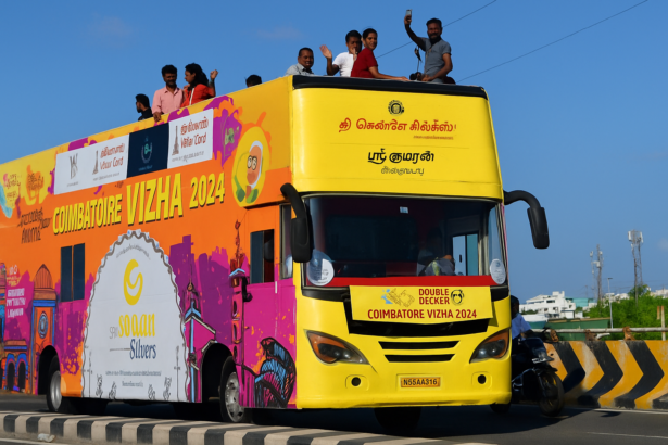 Colorful Coimbatore Vizha 2024 double-decker bus with people celebrating the city festival on Avinashi Road, Coimbatore.