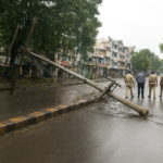 Fallen electric pole on V.K.K. Menon Road in Gandhipuram causing traffic disruption and police inspection in Coimbatore