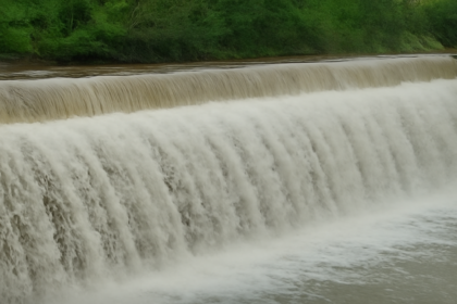 Overflowing water at a dam in Coimbatore after continuous heavy rainfall in northern regions, increasing inflow and water levels.