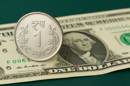 Indian Rupee coin placed over US Dollar note representing currency correction