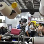 Visitors exploring advanced machinery at the Coimbatore textile accessories spares expo during SIMA Texfair 2026 at CODISSIA Trade Fair Complex